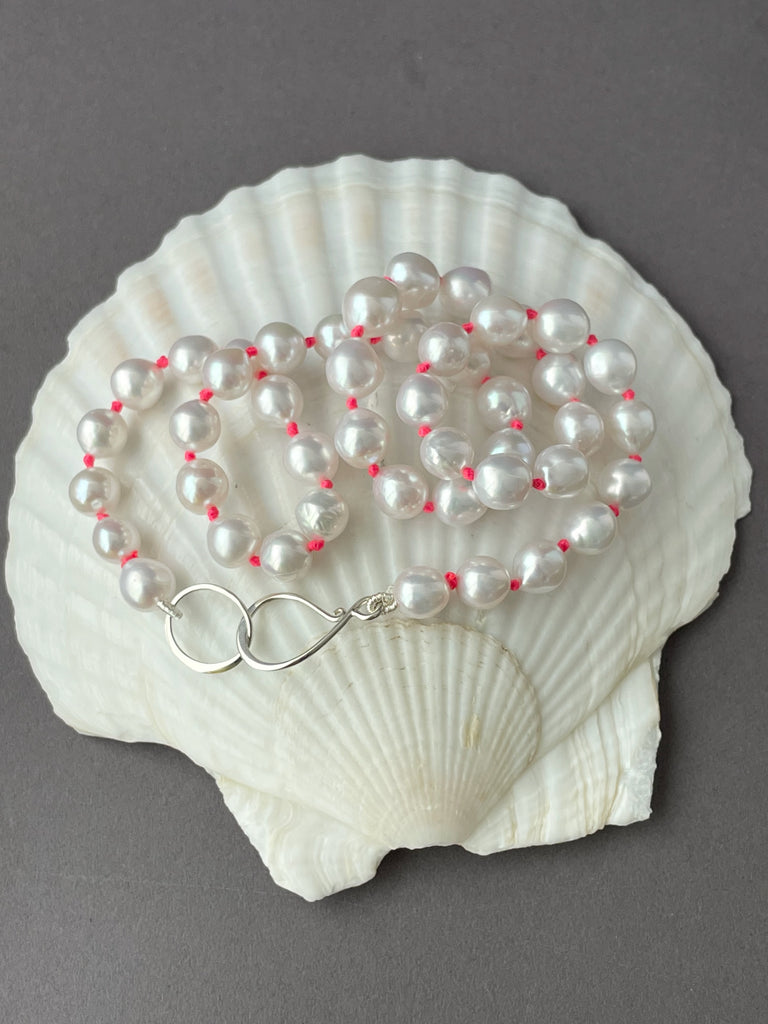 classic white pearls on neon pink knots