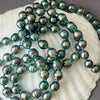 rope of 7mm circlé Tahitian pearls on blue knots