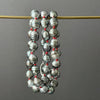 TINY SILVER TAHITIAN PEARLS ON RED KNOTS NECKLACE