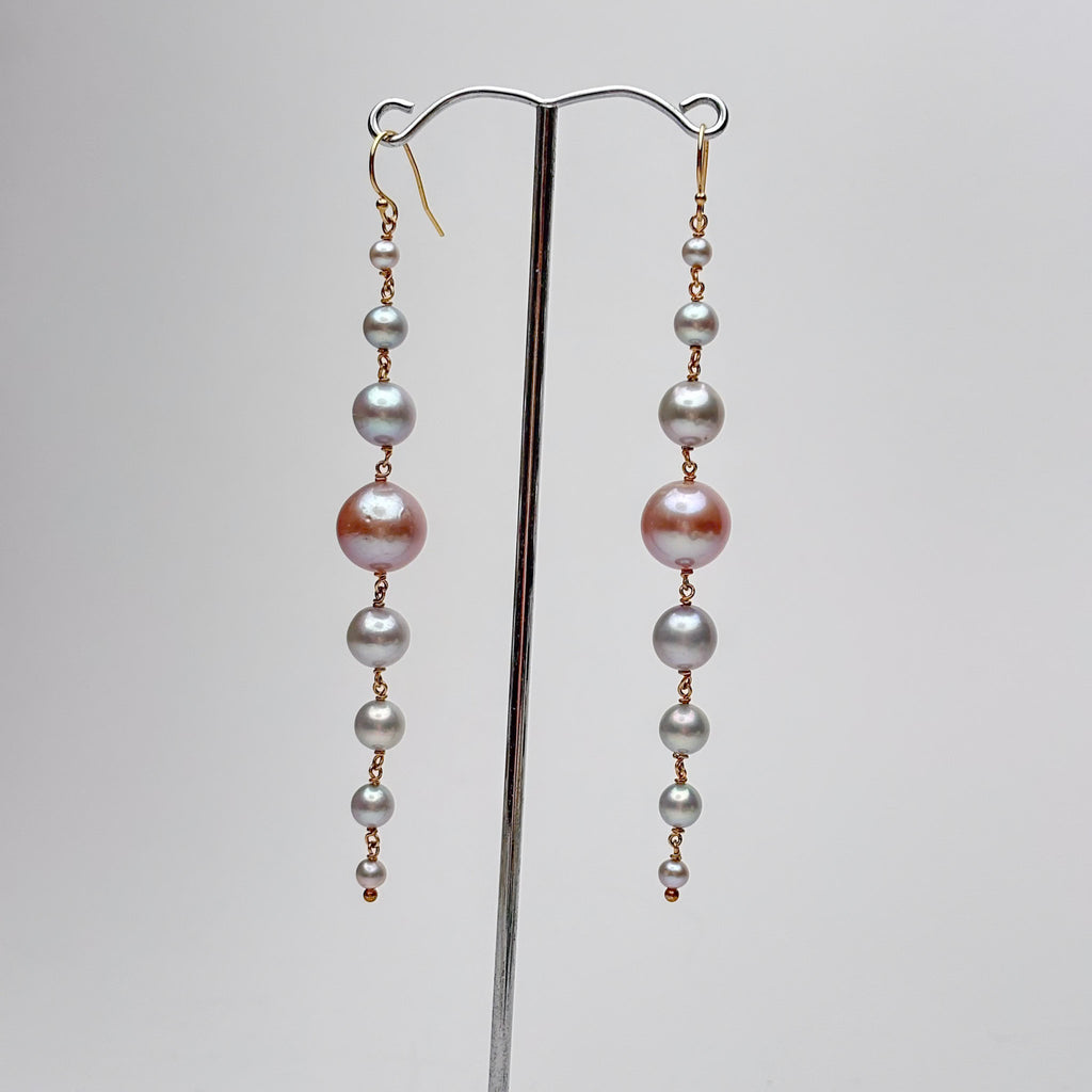 long cascade earrings made of silver and pink pearls in graduating sizes