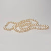 Akoya pearl necklace on a light gray background