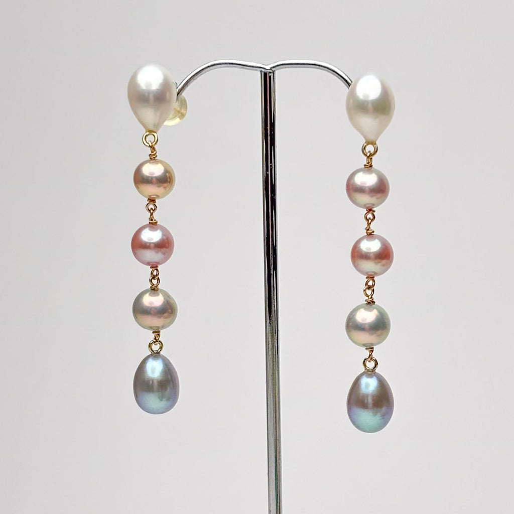 five tier ombre pearl earrings on a stand against a white background