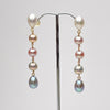 five tier ombre pearl earrings on a stand against a white background