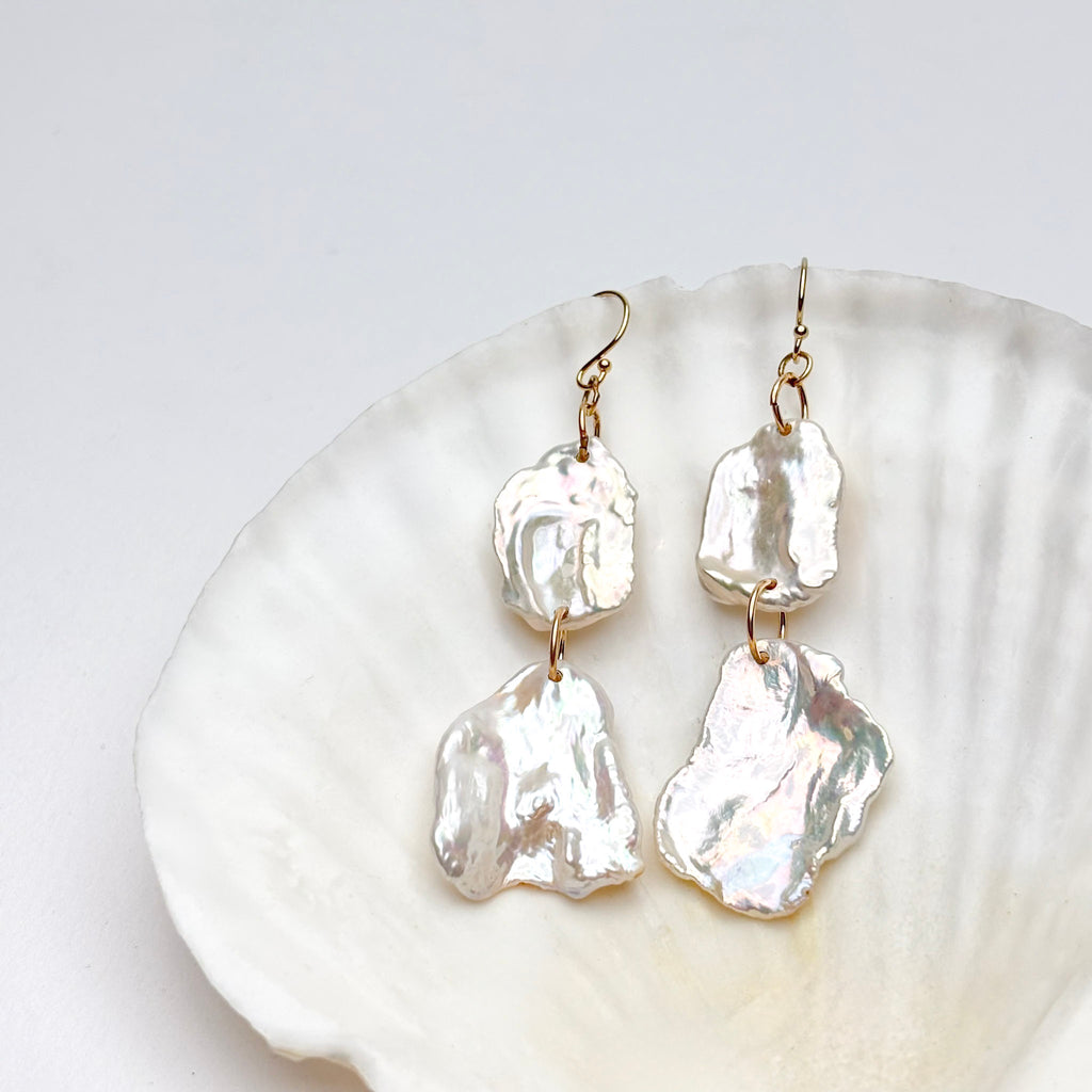 two tier petal Pearl earrings on a white shell background