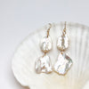 two tier petal Pearl earrings on a white shell background