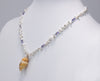 Chinese Freshwater keshi Necklace with Tanzanites and a Cone Shell